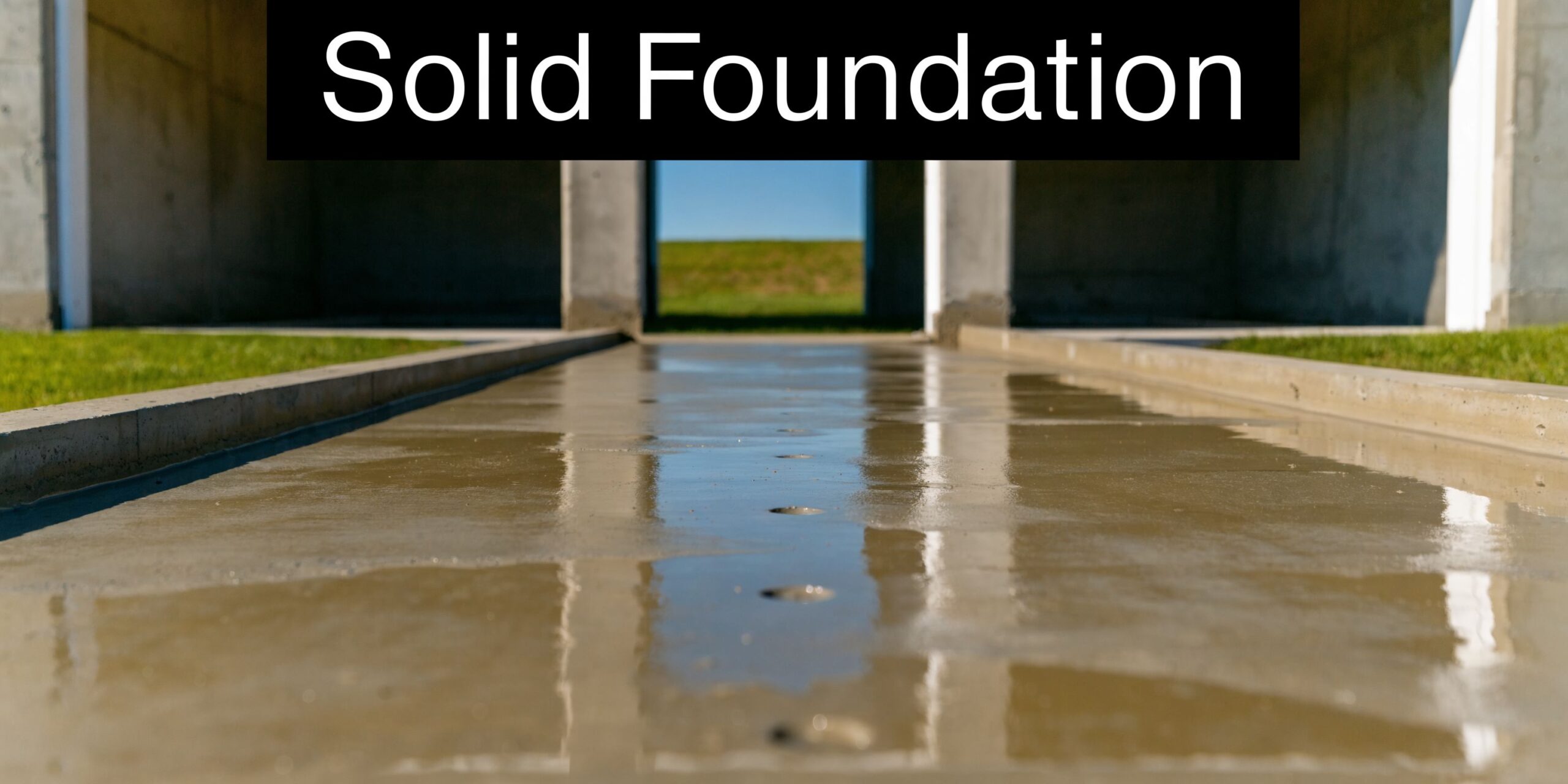 How Big Garage Should You Build? PA & MD Guide 4 A fresh concrete foundation for a new garage project with a bright outdoor view through pillars.